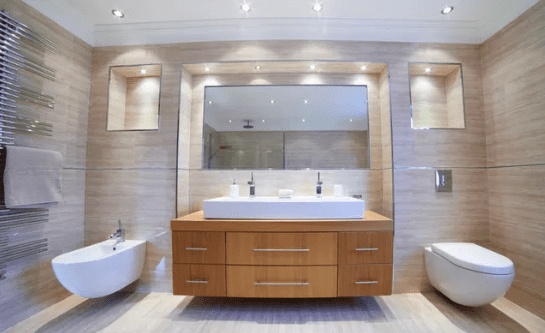 A bathroom with two sinks and a large mirror.